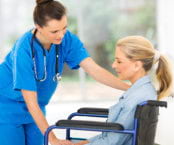 nurse helping senior woman in a wheelchair