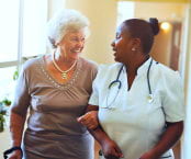 senior woman and caregiver smiling each happy